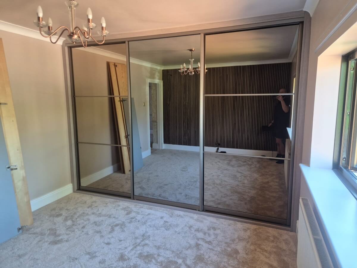 VERTEX in a Champagne frame - three-equal-split bronze mirror doors alongside a full-panel silver mirror, making the most of the light.