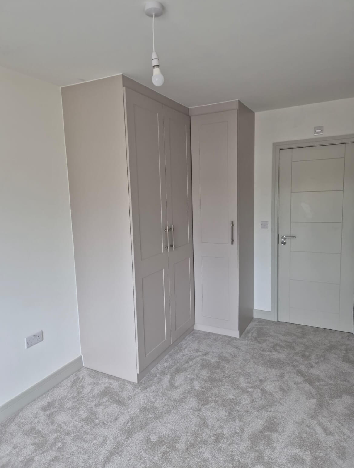Grey shaker fitted wardrobe in an L-shaped corner design, fitted in a new-build bedroom in Boldmere, Sutton Coldfield
