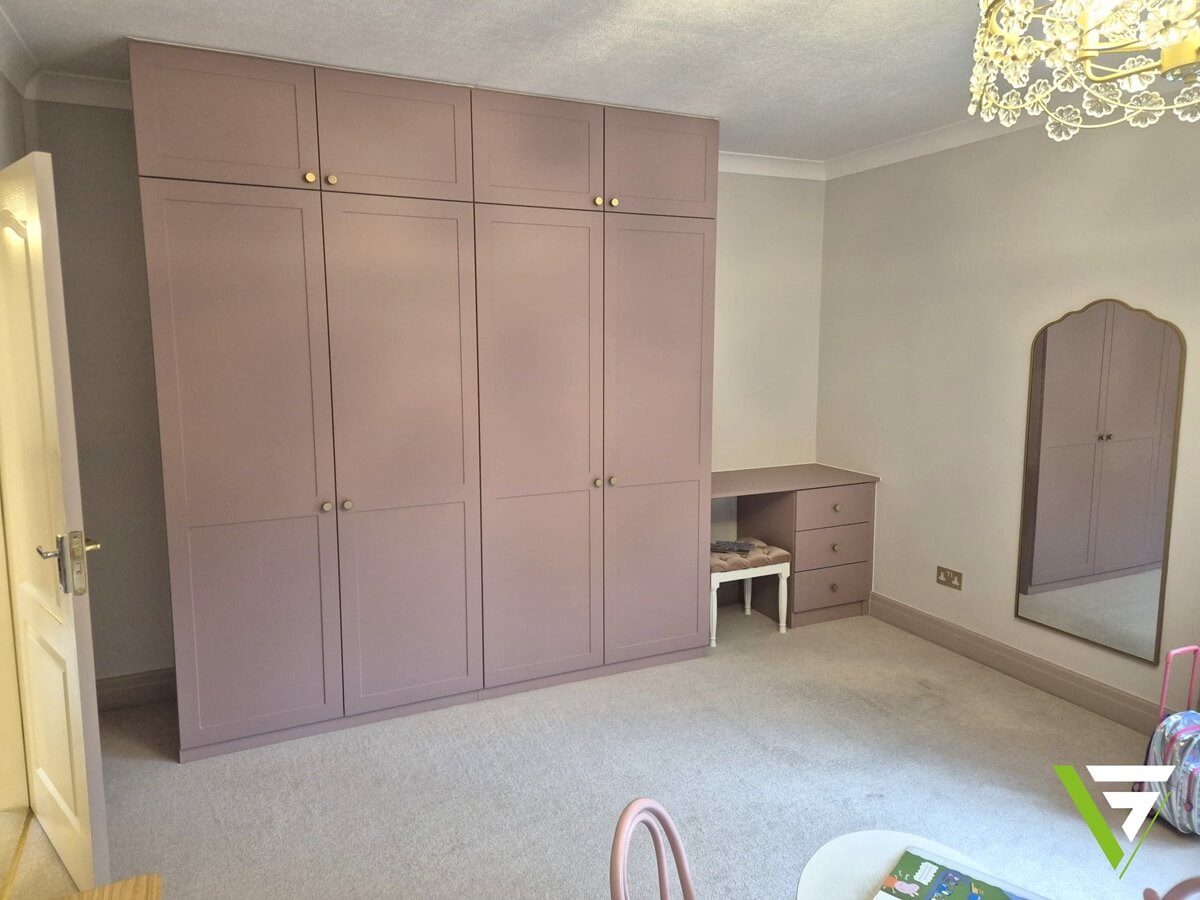 Bespoke dusky pink shaker fitted wardrobe with a matching desk and drawers in a Sutton Coldfield bedroom