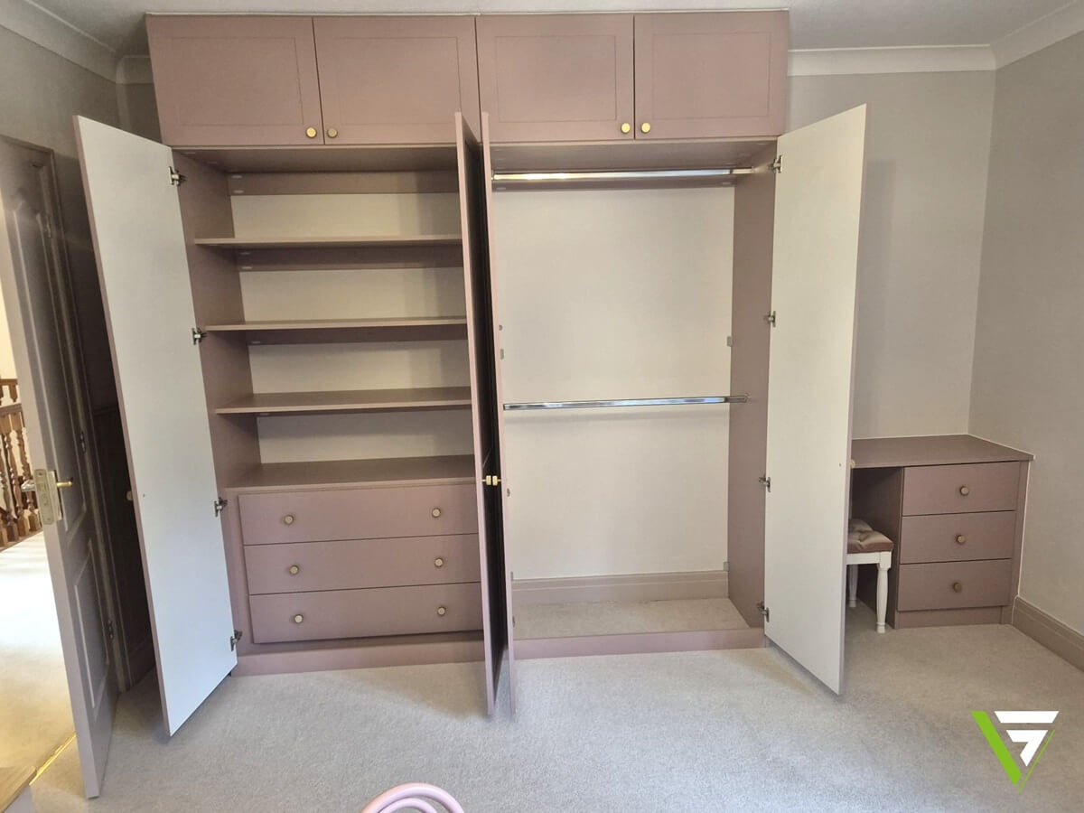 Inside a Sutton Coldfield fitted wardrobe - adjustable shelves, deep drawers and double hanging rails in dusky pink