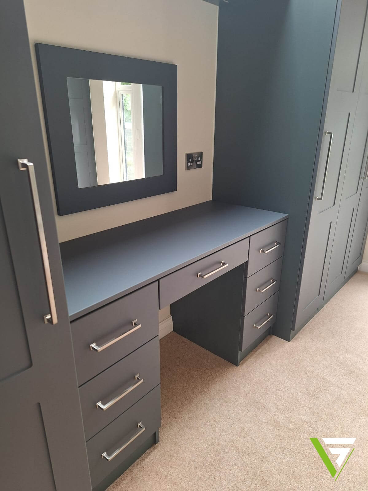 Built-in dressing table in Heritage Green with a centre drawer and three drawers each side, between fitted wardrobes in Tamworth