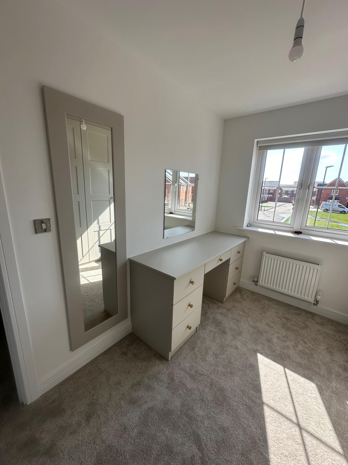 Cashmere hinged wardrobes either side of a built-in dressing table with mirror, Gloucester bedroom