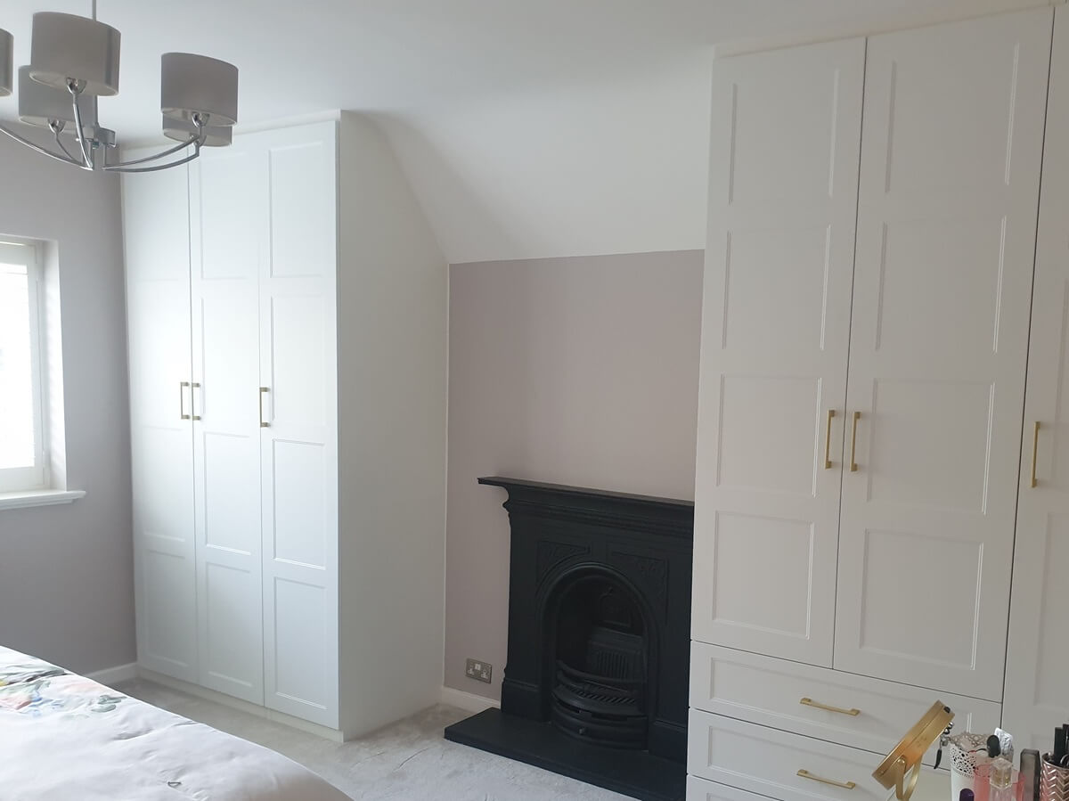White hinged fitted wardrobes beside a period cast-iron fireplace, Sutton Coldfield bedroom