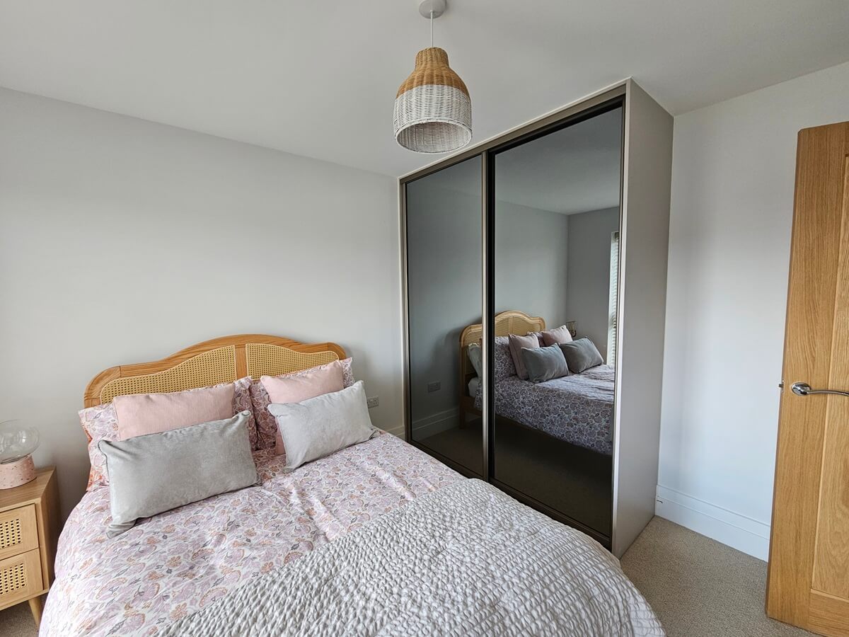 Grey mirror sliding wardrobe with a champagne frame — bespoke sliding wardrobes for Sutton Coldfield bedrooms
