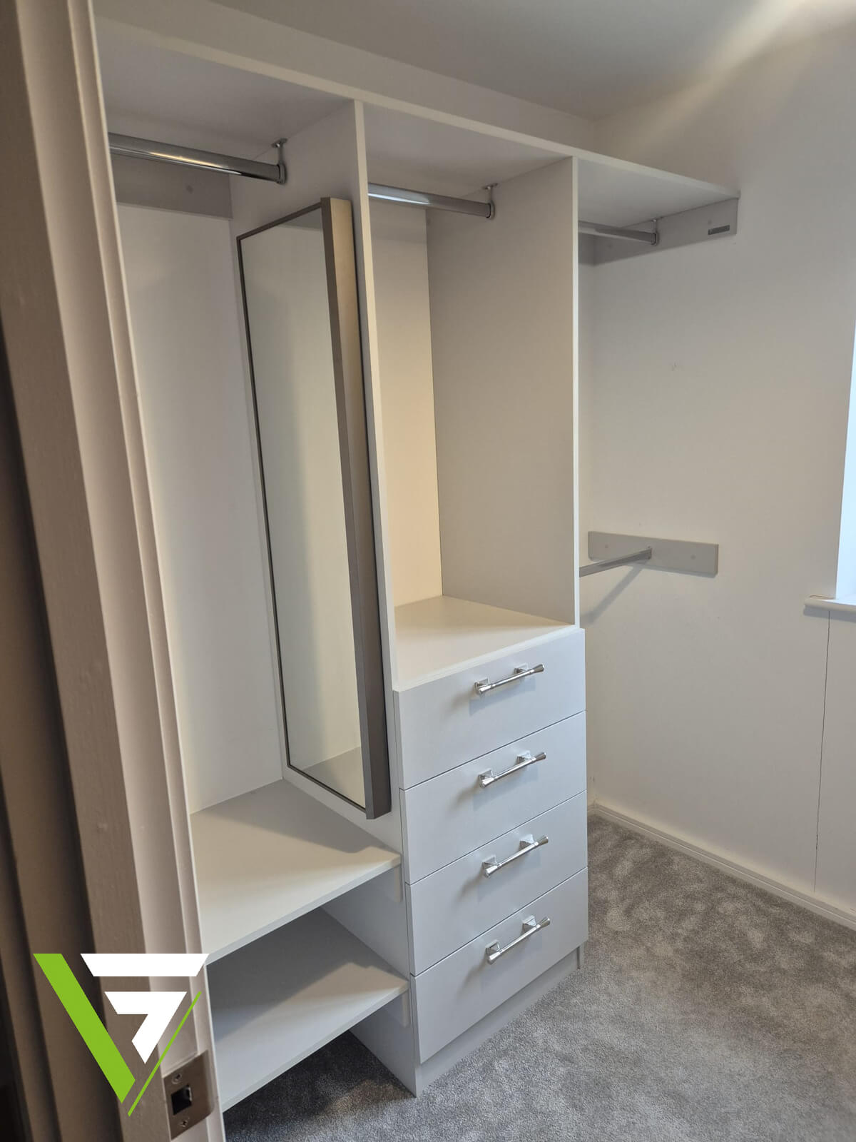 Walk-in dressing room in Wolverhampton with three hanging rails, a four-drawer unit, open shelves and a full-length mirror in white and light grey