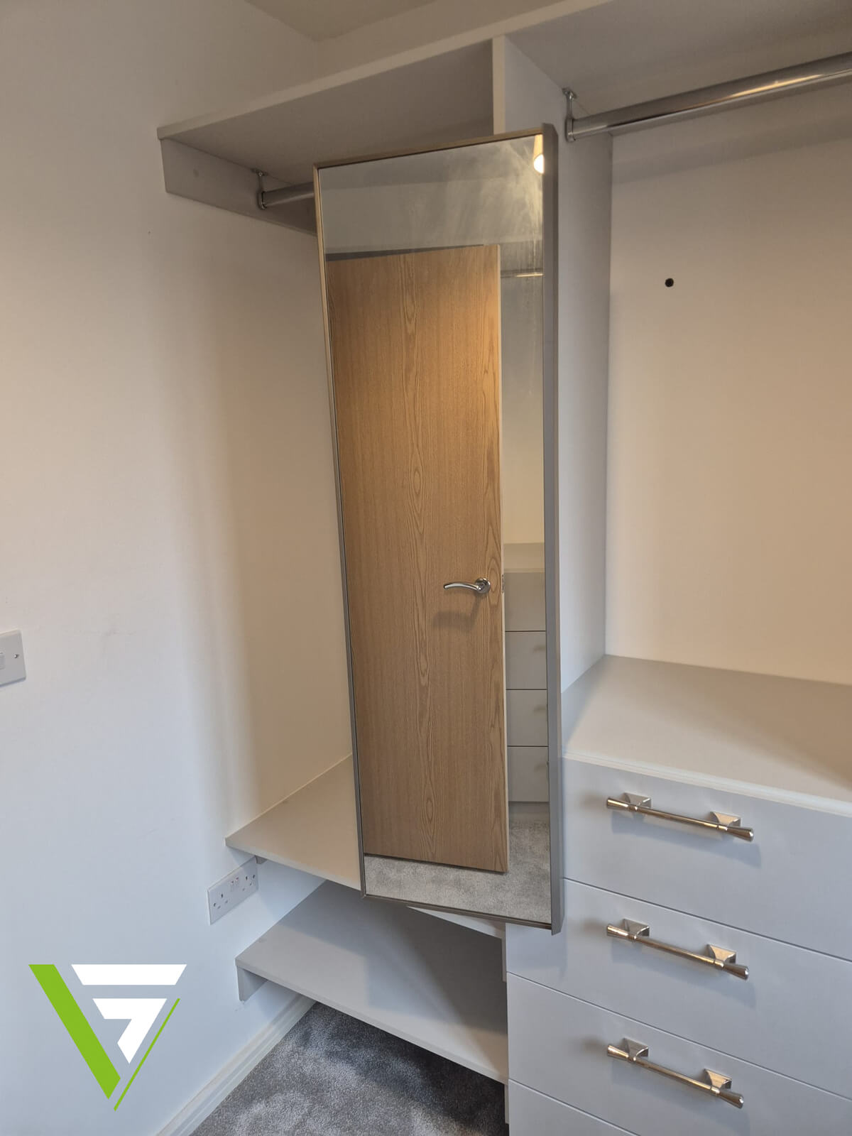 Walk-in dressing room interior in Wolverhampton with a hanging rail, full-length mirror, open shelves and a drawer unit with chrome handles